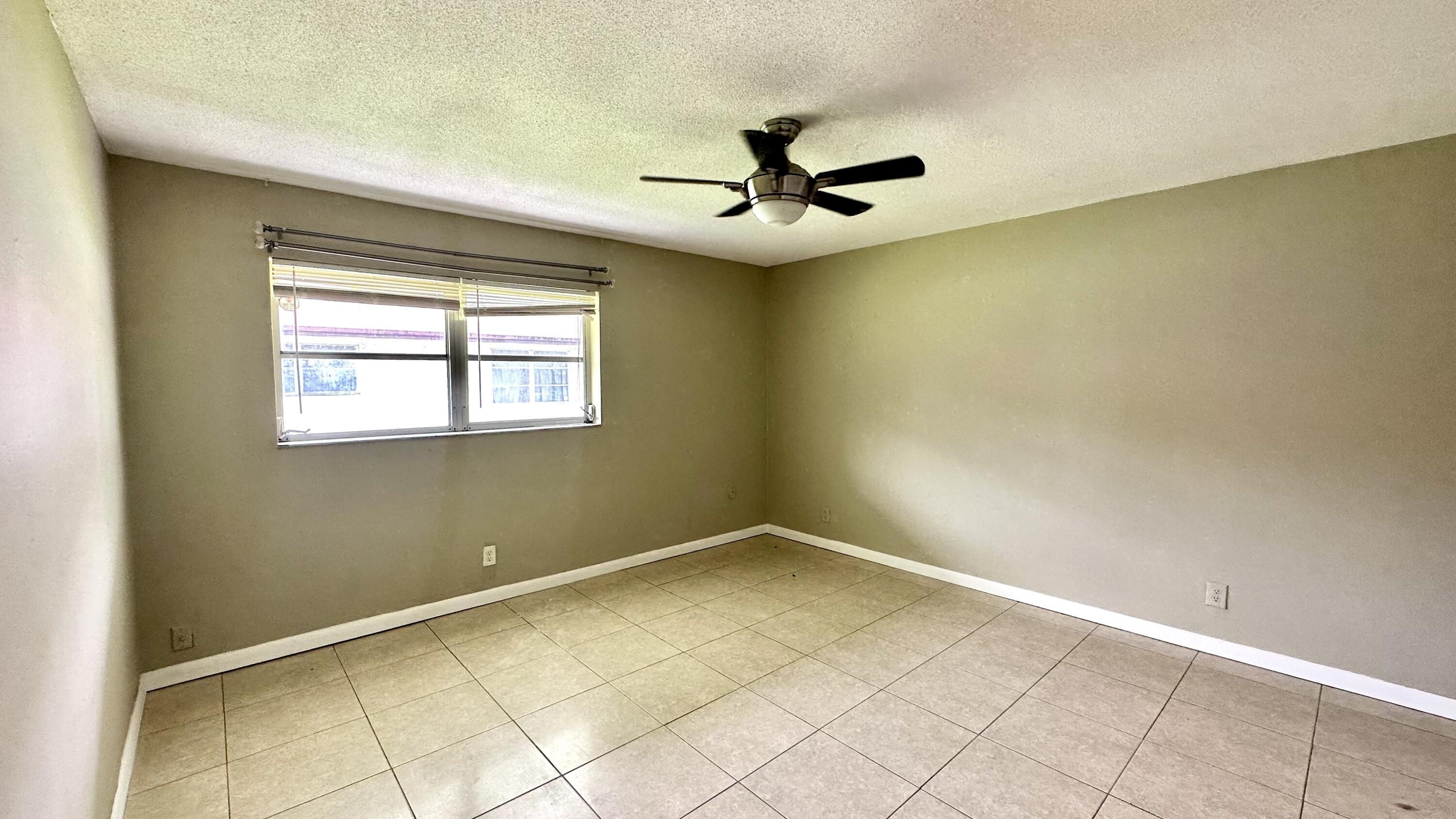 5745 Buchanan Street Hollywood, FL 33021 - Photo 6 of 20 an empty room with windows and fan