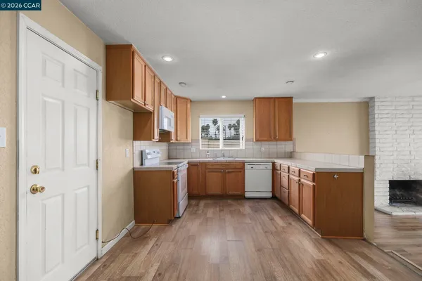 a kitchen with cabinets a sink and wooden floor
