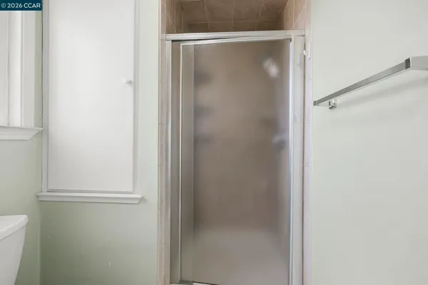 a bathroom with a glass shower door