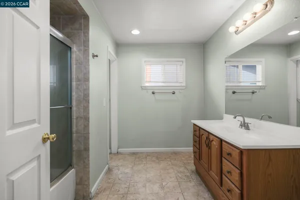 a bathroom with a sink a mirror and a shower