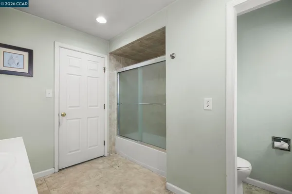 a bathroom with a shower and a toilet