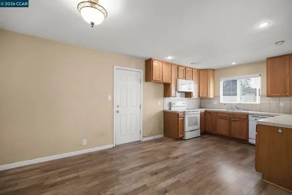 a kitchen with a sink wooden cabinets and counter top space