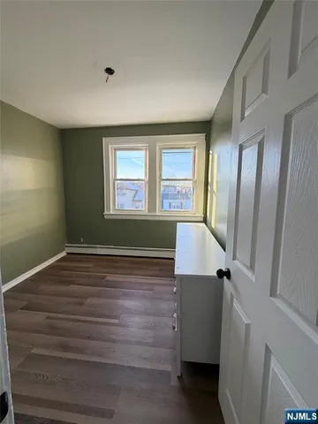 a view of a room with window and wooden floor