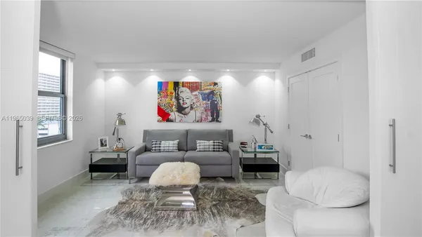 a bedroom with furniture and a window