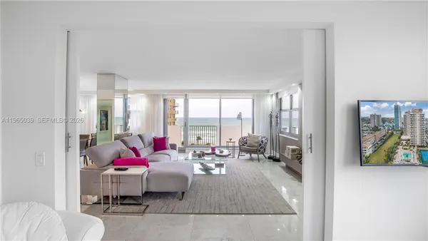 a living room with furniture and a floor to ceiling window