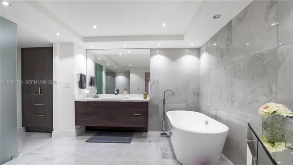 a bathroom with a double vanity sink toilet mirror and shower