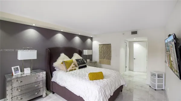 a spacious bedroom with a bed and a couch