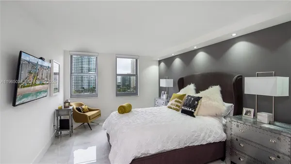 a bedroom with a bed and lamp