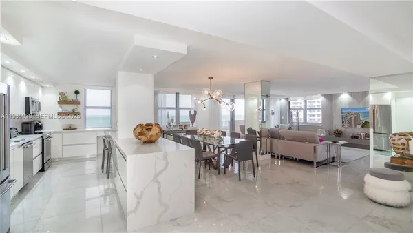 a living room with furniture and view of dining room