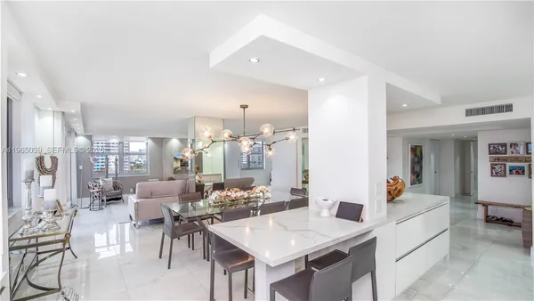 a view of a dining room with furniture and chandelier