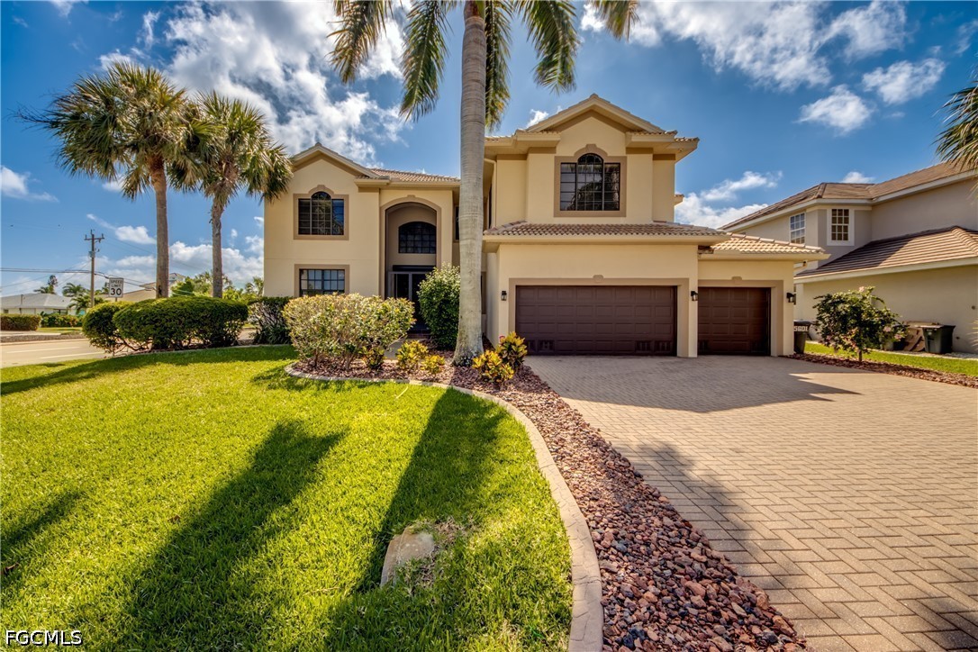 5601 Del Rio Court Cape Coral, FL 33904 - Photo 1 of 50 a front view of a house with swimming pool