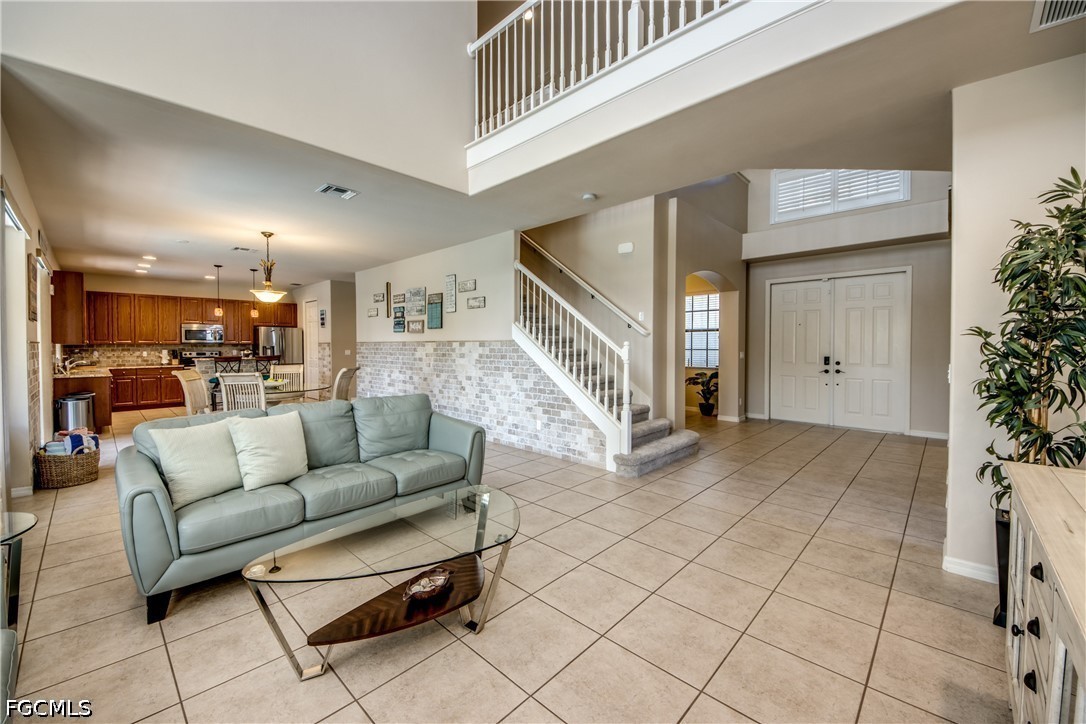 5601 Del Rio Court Cape Coral, FL 33904 - Photo 12 of 50 a living room with furniture and a wooden floor