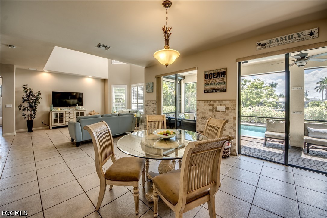 5601 Del Rio Court Cape Coral, FL 33904 - Photo 15 of 50 a dining room with furniture and large windows