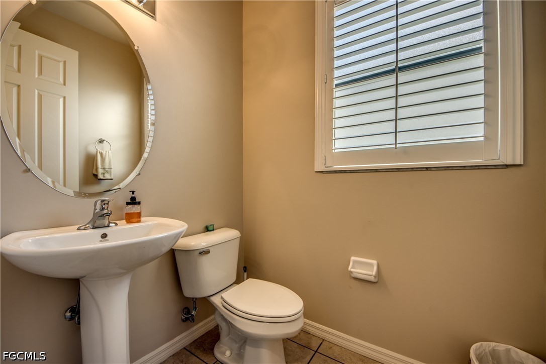 5601 Del Rio Court Cape Coral, FL 33904 - Photo 20 of 50 a bathroom with a toilet sink and mirror