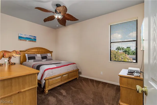 a bedroom with a bed window and a chandelier