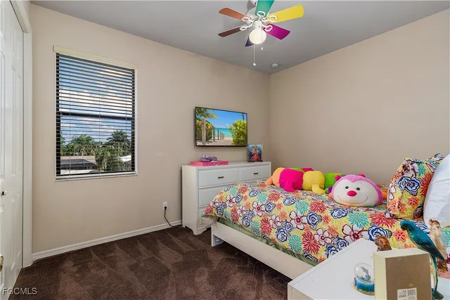 a bathroom with a granite countertop sink a toilet and shower curtain