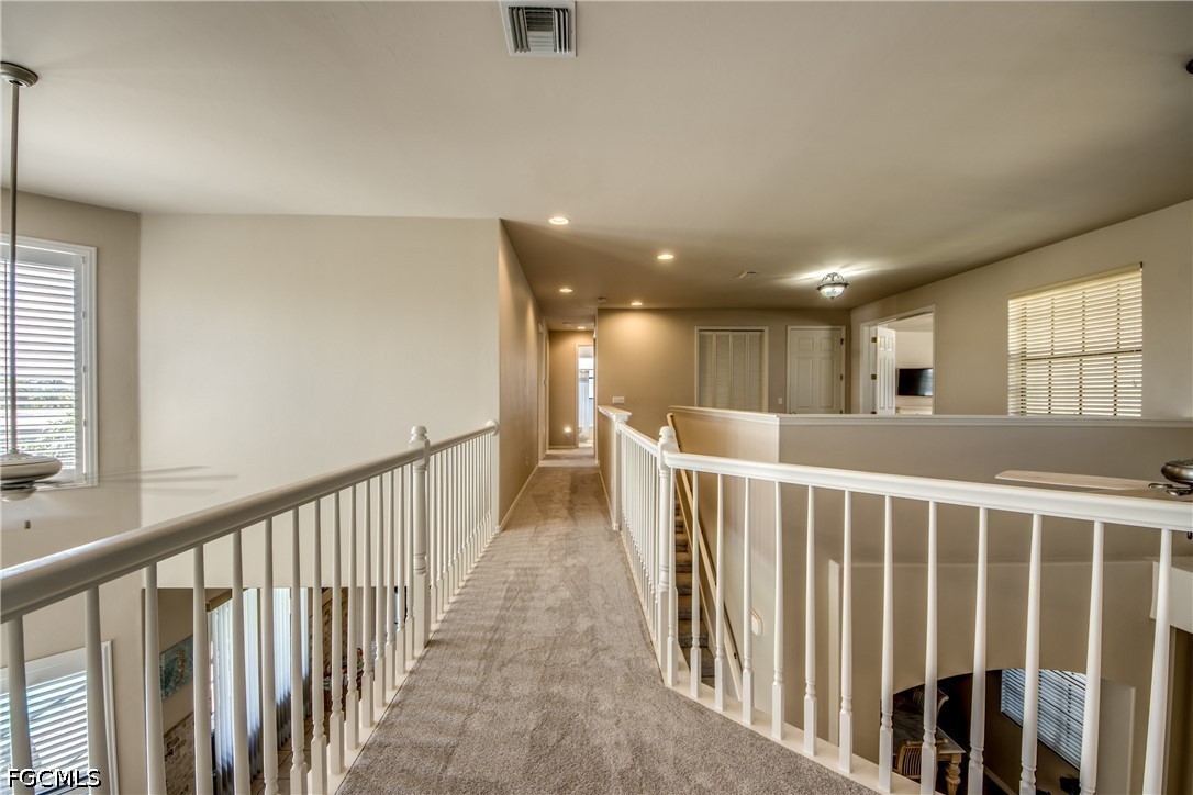 5601 Del Rio Court Cape Coral, FL 33904 - Photo 24 of 50 a view of a hallway with wooden floor and windows