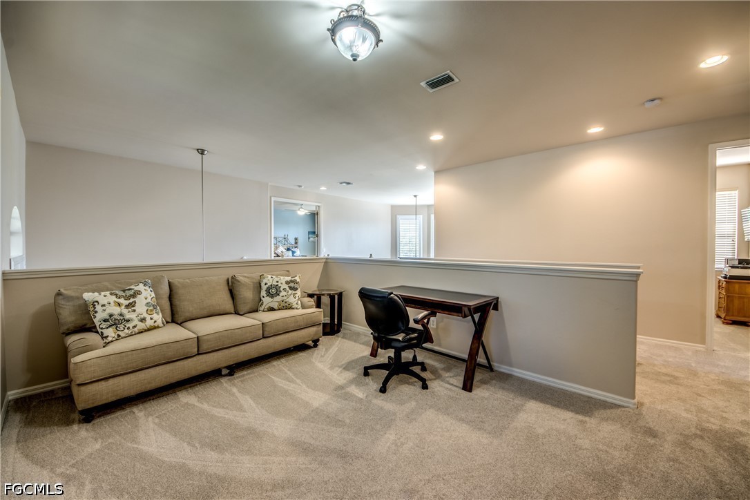 5601 Del Rio Court Cape Coral, FL 33904 - Photo 26 of 50 a living room with furniture and a chandelier