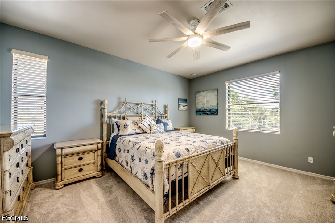 5601 Del Rio Court Cape Coral, FL 33904 - Photo 27 of 50 a bedroom with a bed and a chandelier