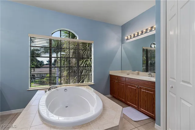 a view of bathroom with a sink and mirror