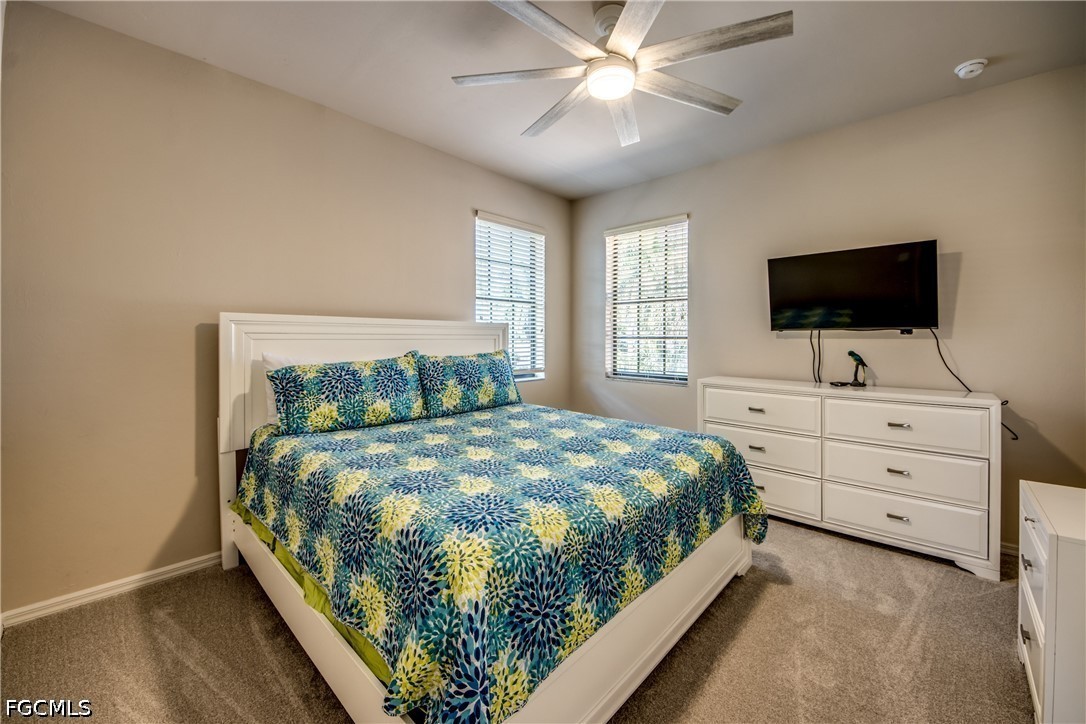5601 Del Rio Court Cape Coral, FL 33904 - Photo 37 of 50 a bedroom with a bed and a flat tv screen on dresser