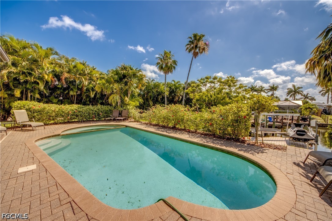 5601 Del Rio Court Cape Coral, FL 33904 - Photo 45 of 50 a view of a swimming pool with a outdoor seating