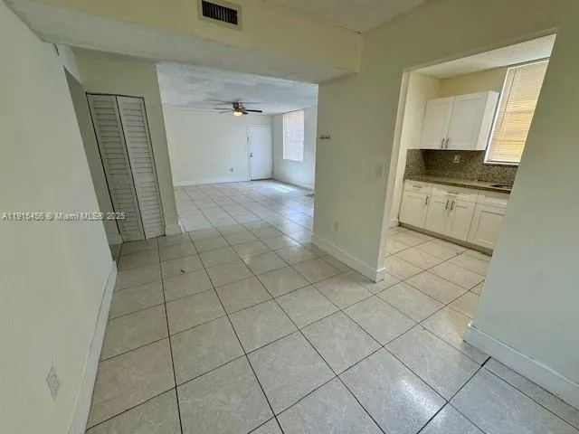 a bathroom with a granite countertop toilet and a sink