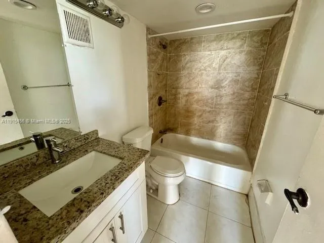 a bathroom with a black shower curtain