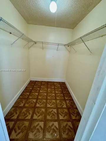 a view of an empty room and a window