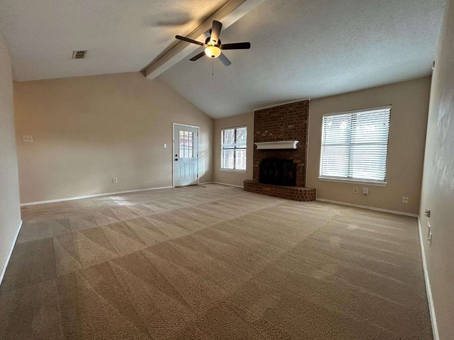 5917 74th Street Lubbock, TX 79424 - Photo 2 of 9 a view of empty room with a fireplace