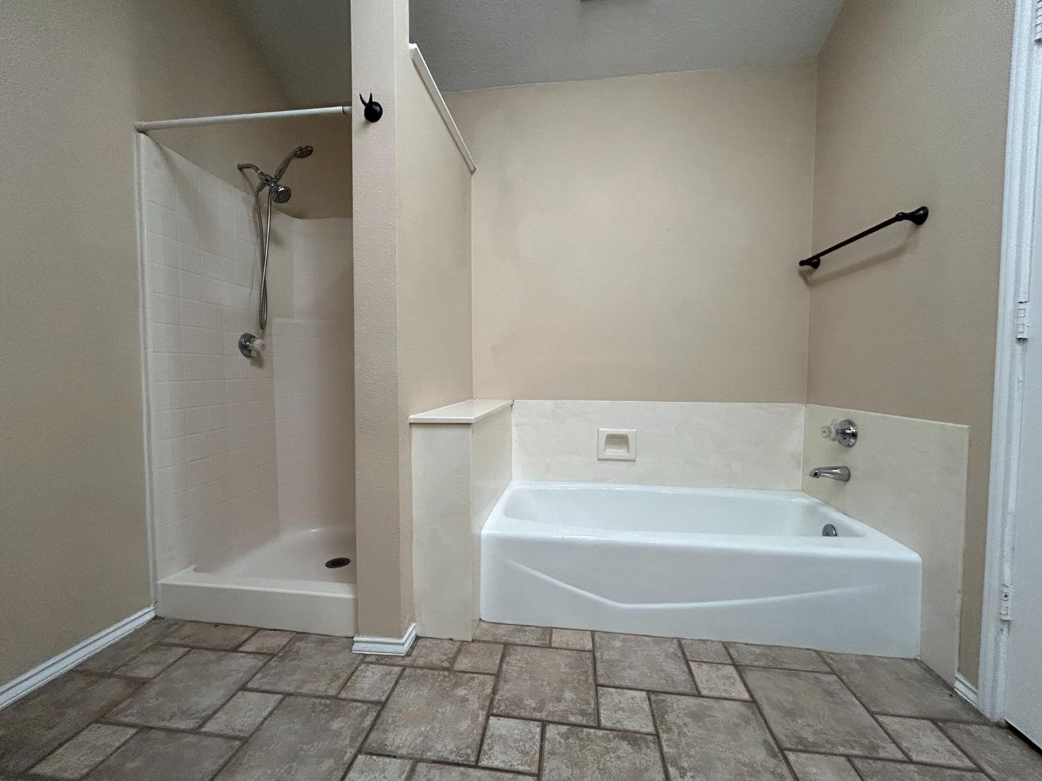 5917 74th Street Lubbock, TX 79424 - Photo 6 of 9 a bathroom with a bathtub