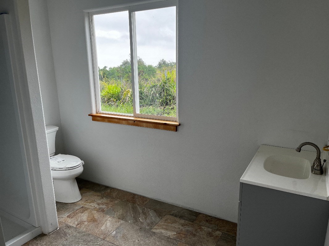 89-1368 Coffee Lots Road Captain Cook, HI 96704 - Photo 5 of 11 a bathroom with a toilet sink and window