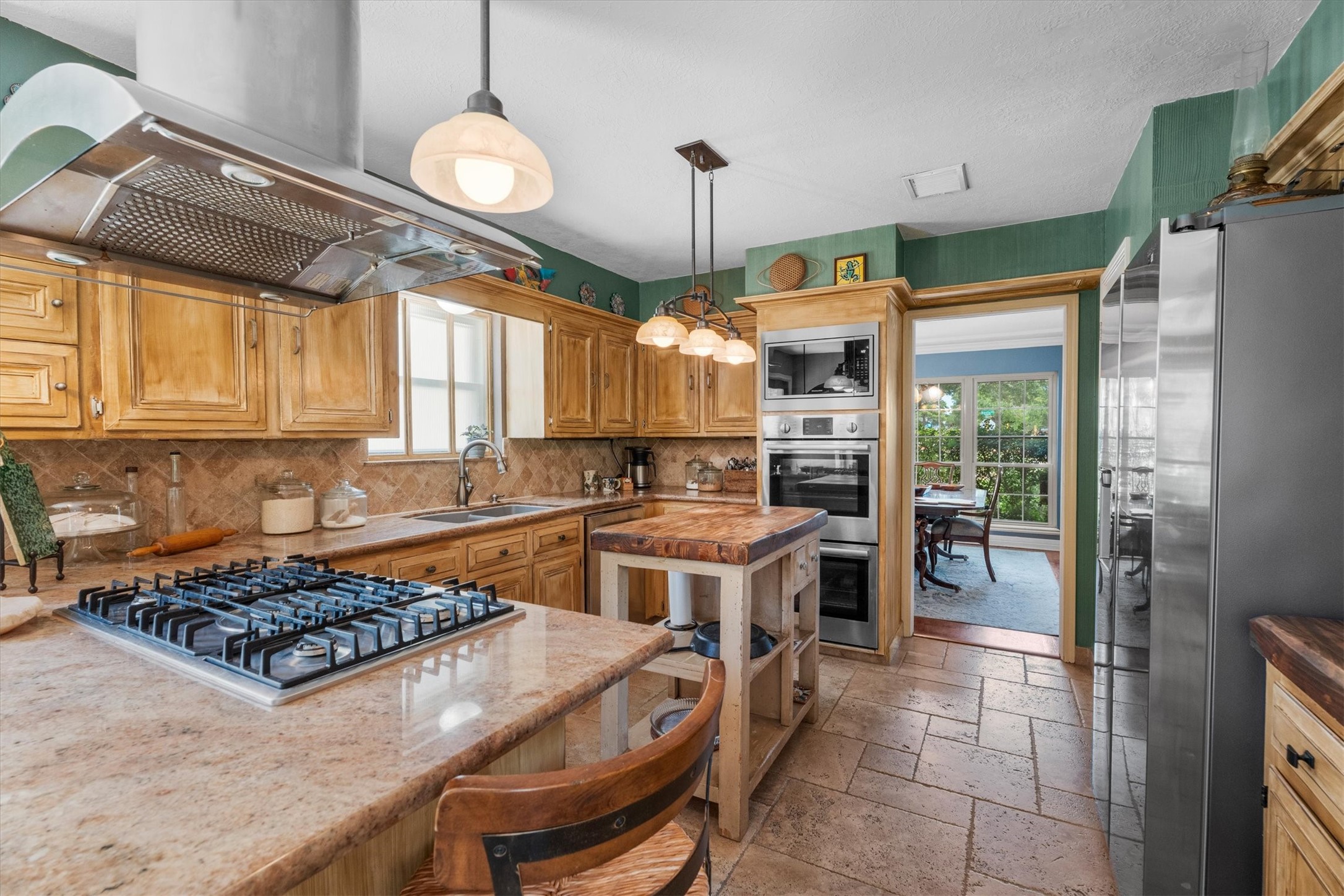 9103 Herts Road Spring, TX 77379 - Photo 15 of 46 Upgraded stainless steel appliances including double ovens and a gas range make this kitchen a chef's paradise. The large, walk-in pantry is located just beyond the fridge.