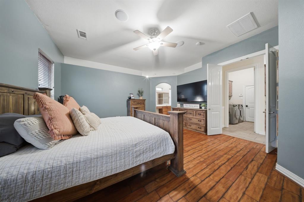 603 Cedar Drive Pilot Point, TX 76258 - Photo 16 of 39 Expansive room featuring wood-finish flooring, a ceiling fan, and light blue wall tones with white trim