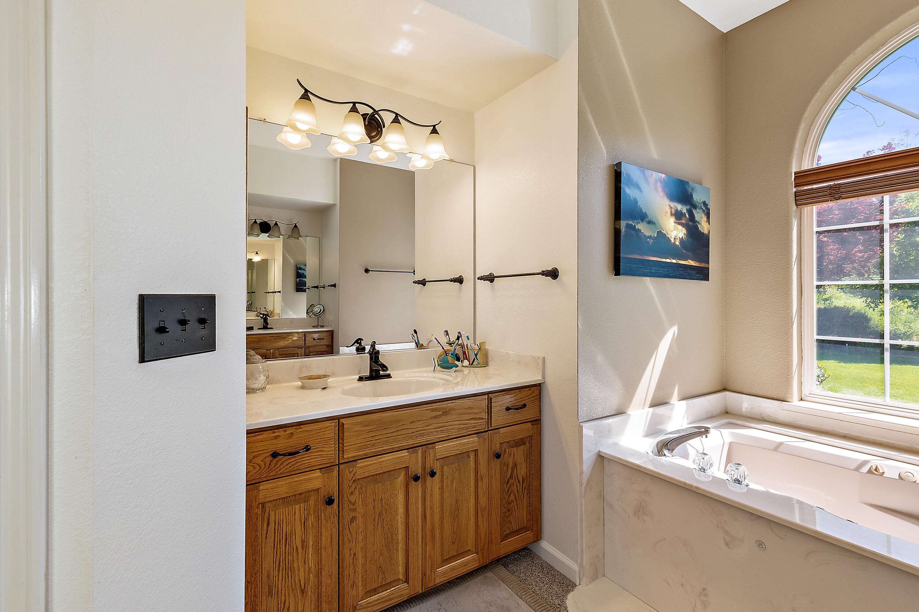 4000 Little Applegate Road Jacksonville, OR 97530 - Photo 26 of 47 a bathroom with a tub sink and mirror