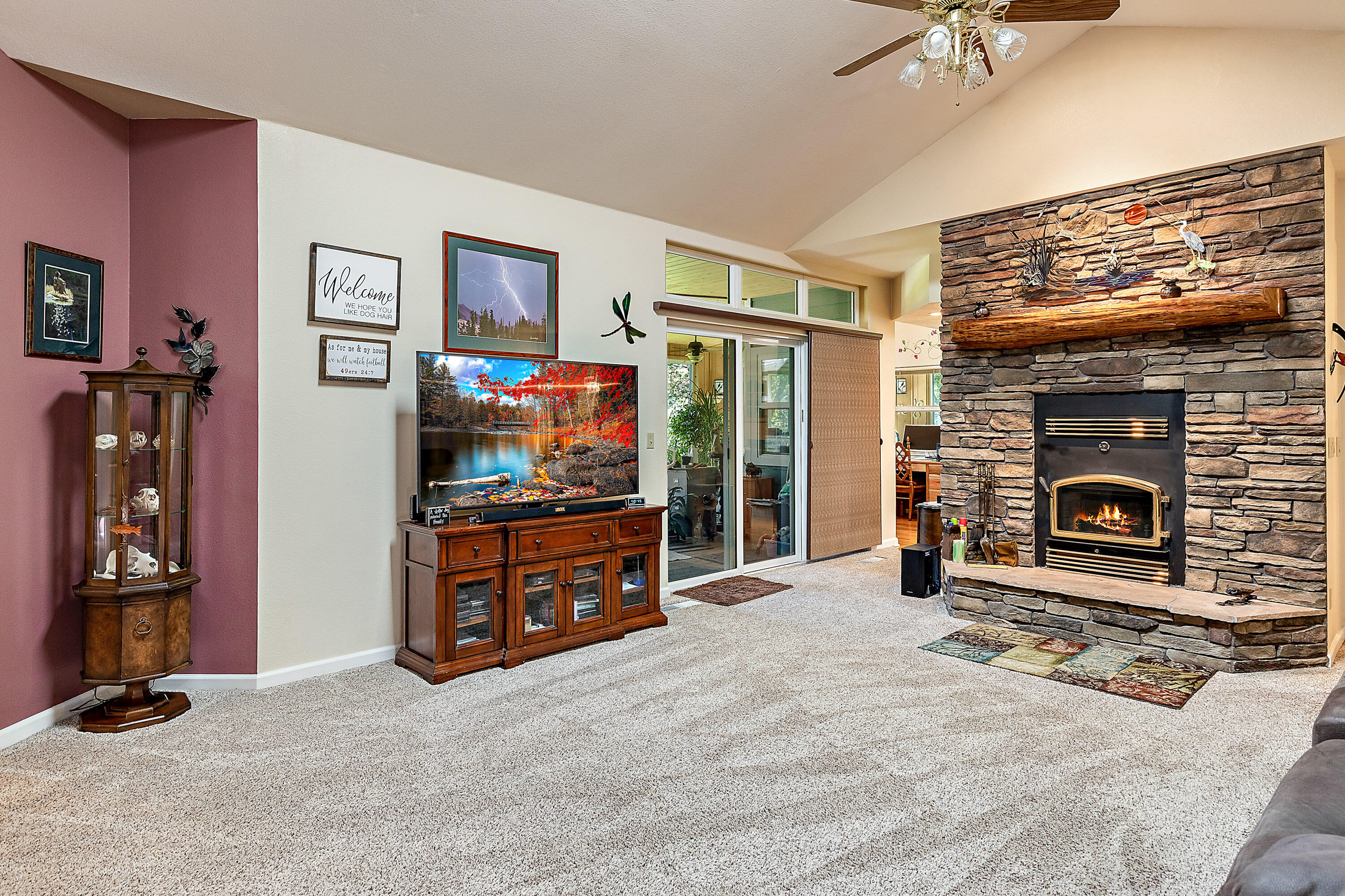 4000 Little Applegate Road Jacksonville, OR 97530 - Photo 8 of 47 a living room with furniture a flat screen tv and a fireplace