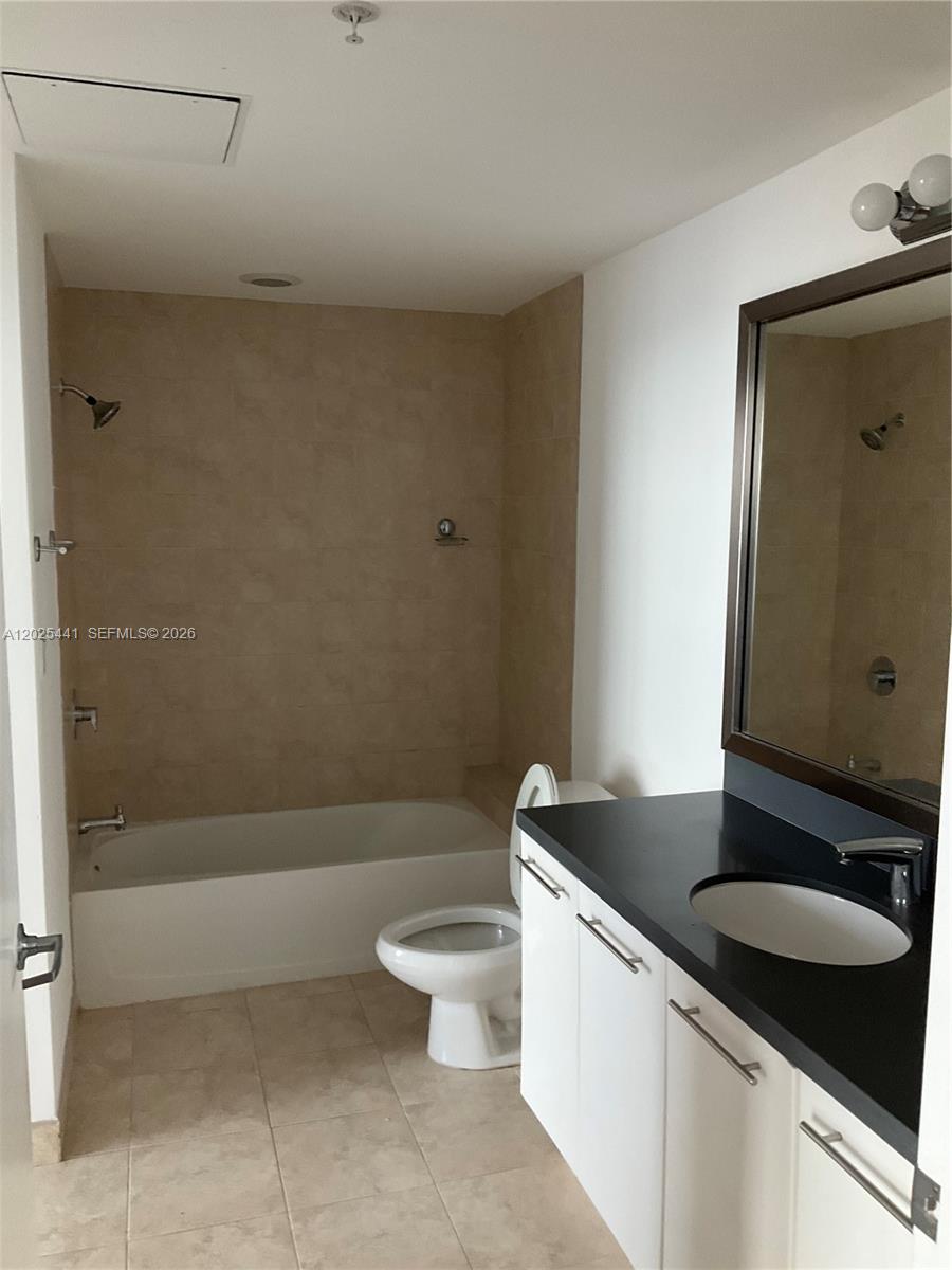 90 Southwest 3rd Street, Unit 3708 Miami, FL 33130 - Photo 6 of 13 a bathroom with a granite countertop sink a toilet and bathtub
