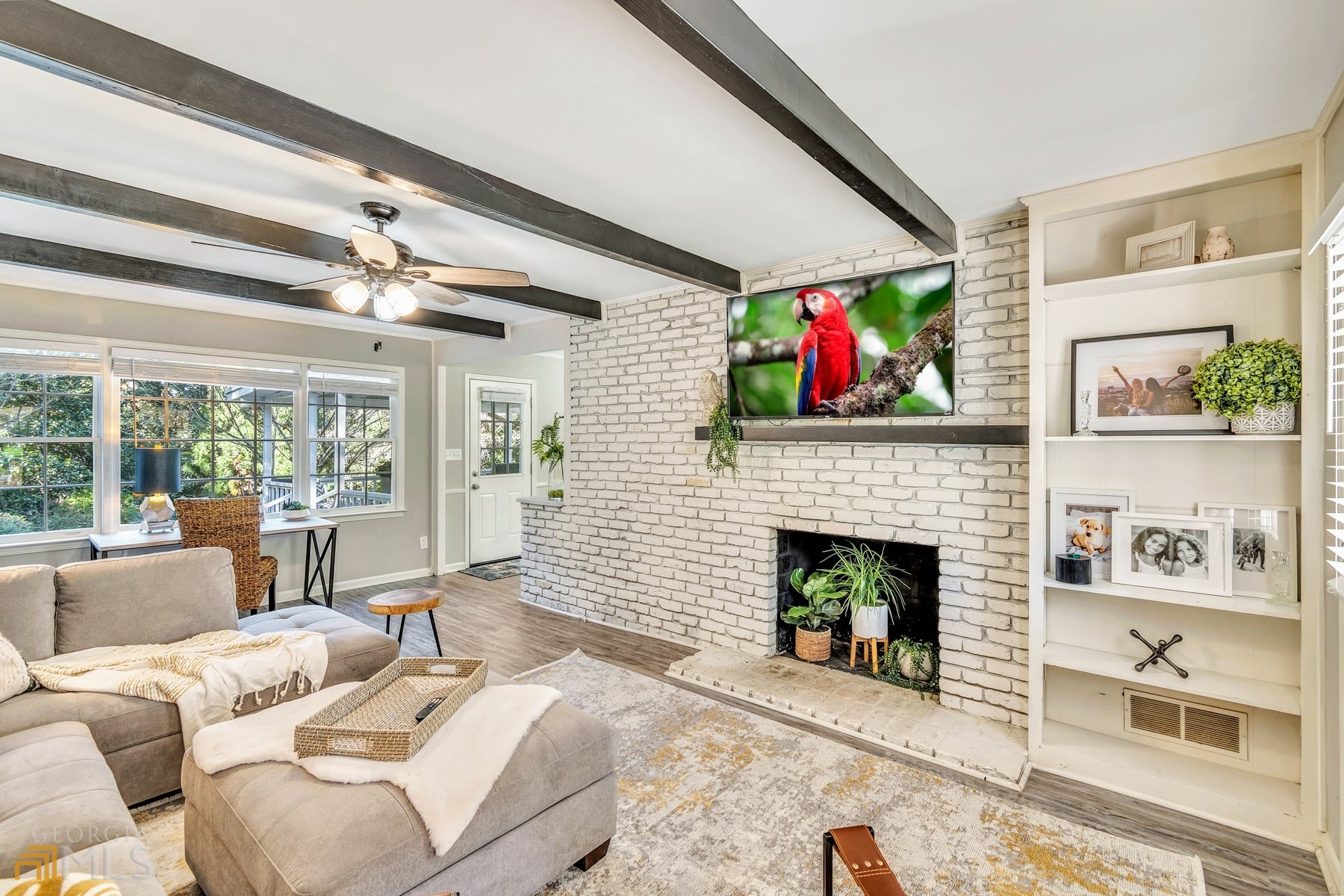 a living room with furniture fireplace and large window