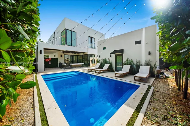 a view of house with swimming pool outdoor seating
