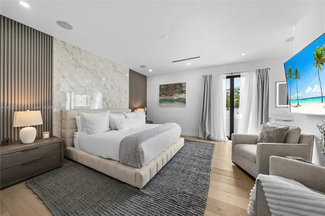 a bedroom with bed couch and window