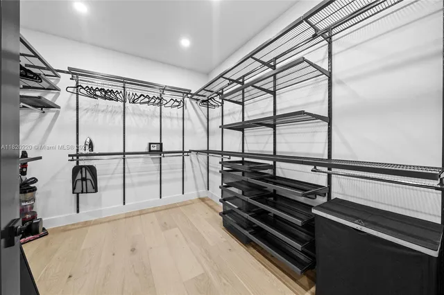 a bathroom with a double vanity sink and mirror with bathtub