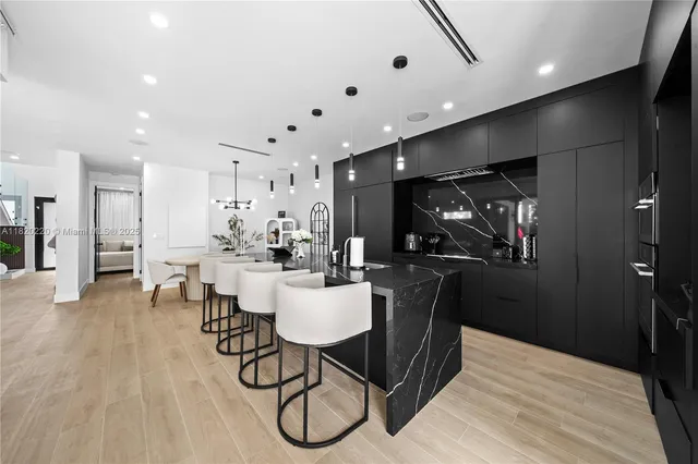 a view of a dining room with furniture wooden floor and chandelier