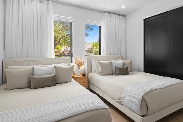 a bedroom with a bed and a large mirror