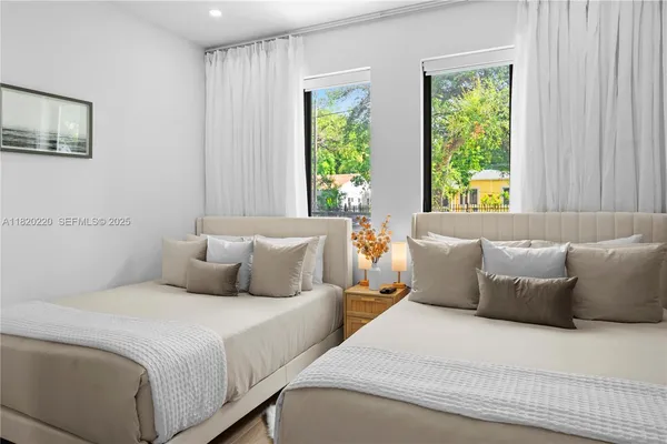 a bedroom with a bed and a large mirror