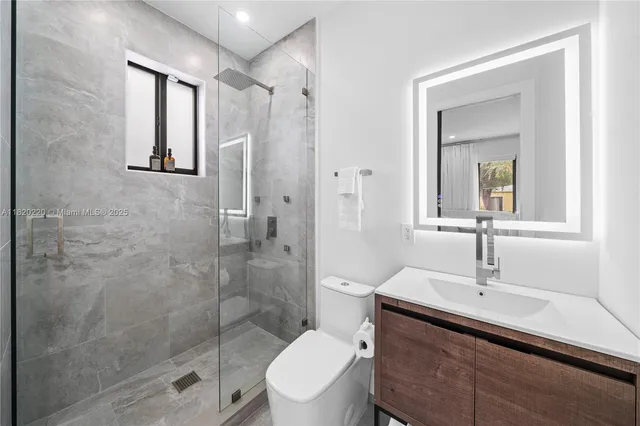 a bathroom with a toilet a sink and shower