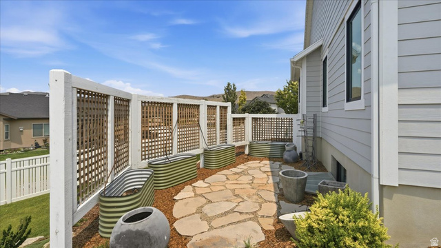 2038 East Ranch Road Eagle Mountain, UT 84005 - Photo 53 of 66 Outdoor patio featuring flagstone paving and raised garden beds