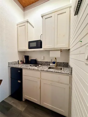 a kitchen with stainless steel appliances granite countertop a sink and a stove
