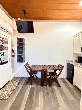 a view of a roof deck with chair and wooden floor