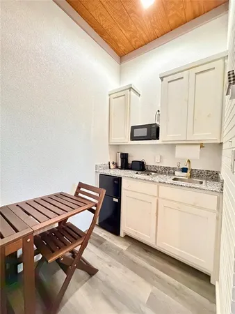 a kitchen with a stove and white cabinets