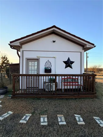 a front view of a house with wooden fence